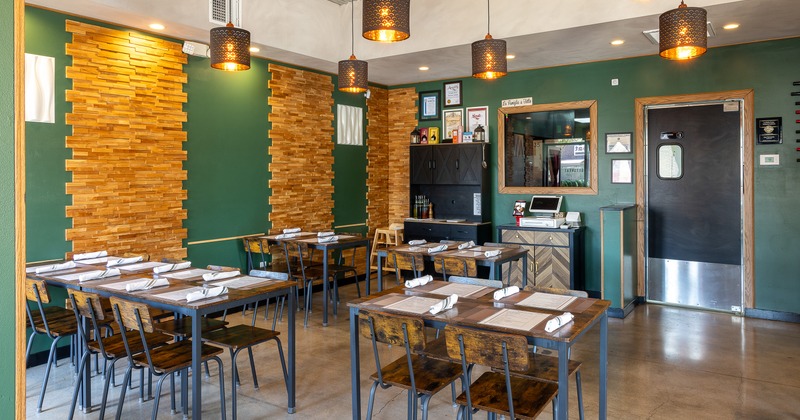Cozy interior dining area with dining tables set for guests