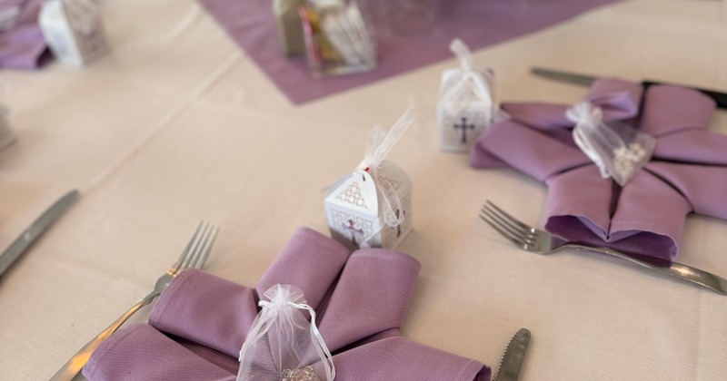 Lavender napkins, utensils, and small gift boxes