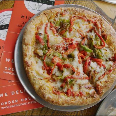 Pizza topped with red and green bell peppers