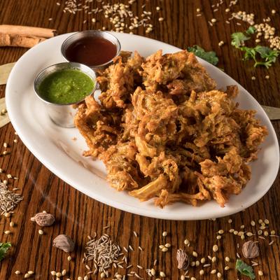Indian-style onion fritters served with green and red chutney.