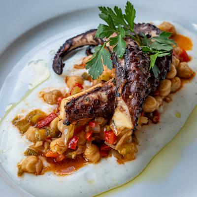 Grilled Spanish octopus served over a chickpea salad and a homemade yogurt sauce.