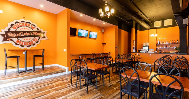 Interior, tables and seating, bar, wall logo and TVs