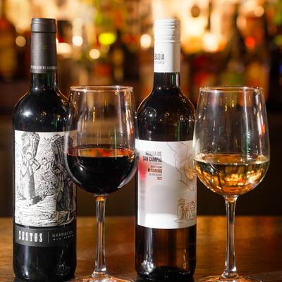 Bottles and glasses of red and white wine.