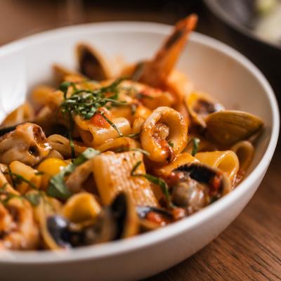 Mixed seafood pasta in tomato sauce.