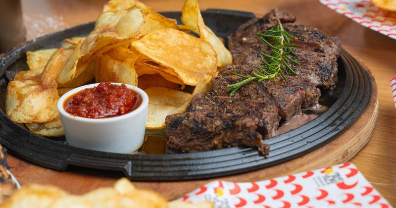 Grilled steak with chips and tomato compote