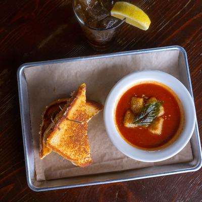 Grilled cheese sandwich and tomato soup, with basil and croutons photo.