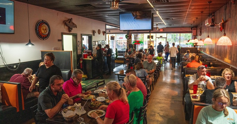 Interior dining area full of guests enjoying their food and drinks
