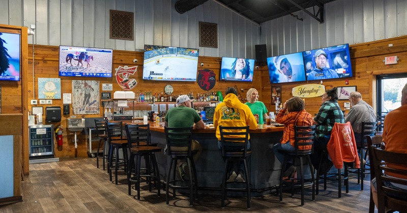Diner and bar area, people, tv screens