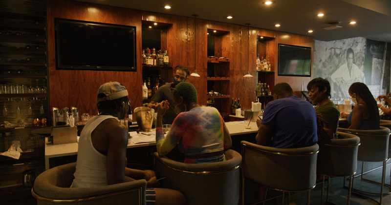 Interior, guests sitting at the bar