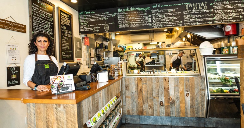 An employee at the checkout counter