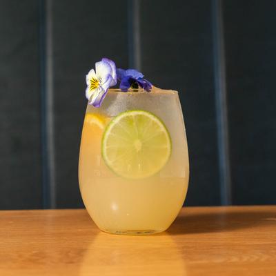 White sangria garnished with flowers.