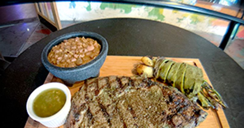 Grilled meat, beans, dip and vegetables