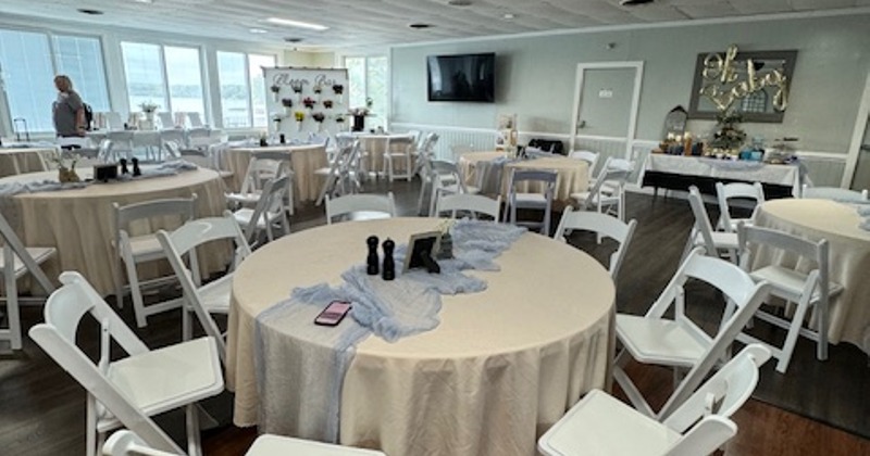 Banquet room with round tables and white chairs