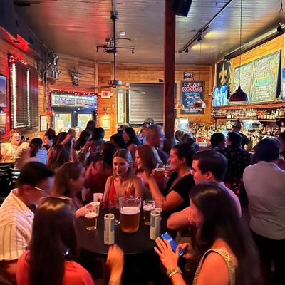 The Rusty Nail, busy bar with people gathered around tables and standing at the bar.
