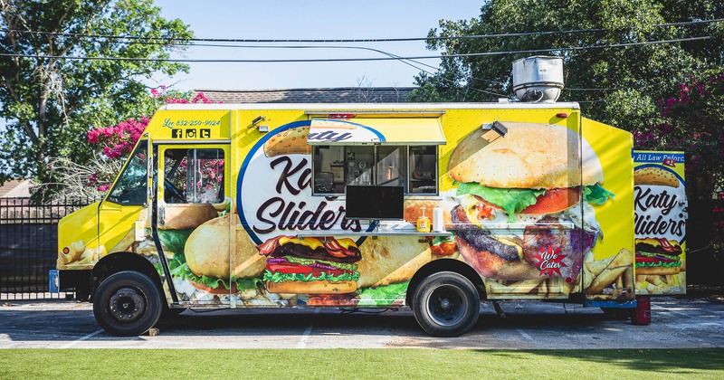 Colorful food van parked near lawn