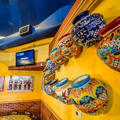Interior with colorful, hand-painted ceramic pottery used as wall decorations.
