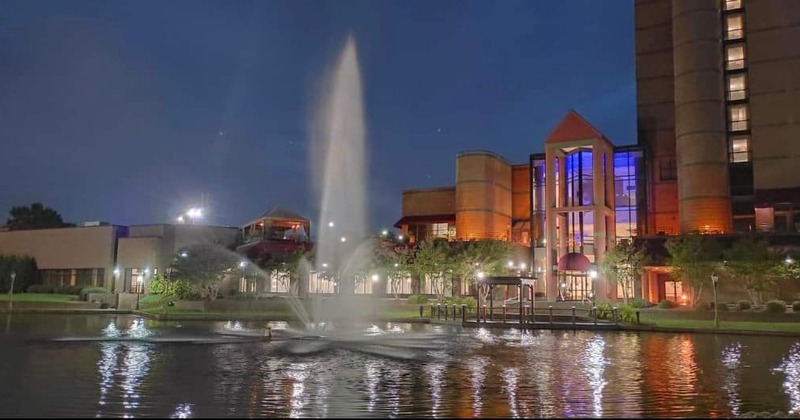Outside, a fountain and buildings in the back
