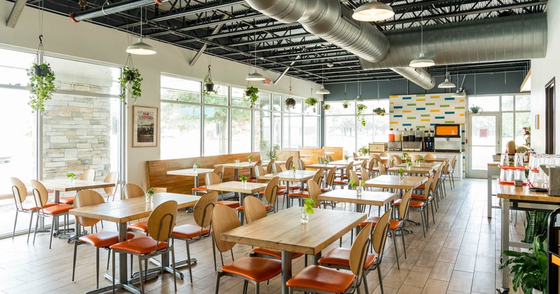 Interior, dining area, wooden top tables with chairs, long wooden bench with tables, entrance