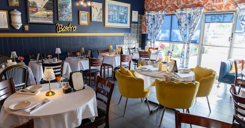 Interior with round tables, white tablecloths and chairs