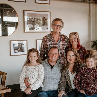 Owners posing with their family inside the restaurant