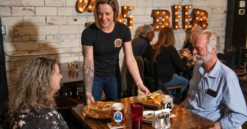 Staff serving guests their food