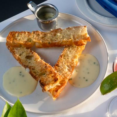 Garlic bread accompanied by four cheese fondue.