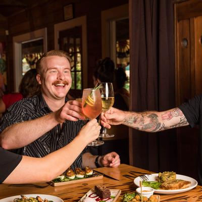 Customers toasting with wine glasses