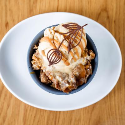 Drunk bread pudding decorated with chocolate tuille.