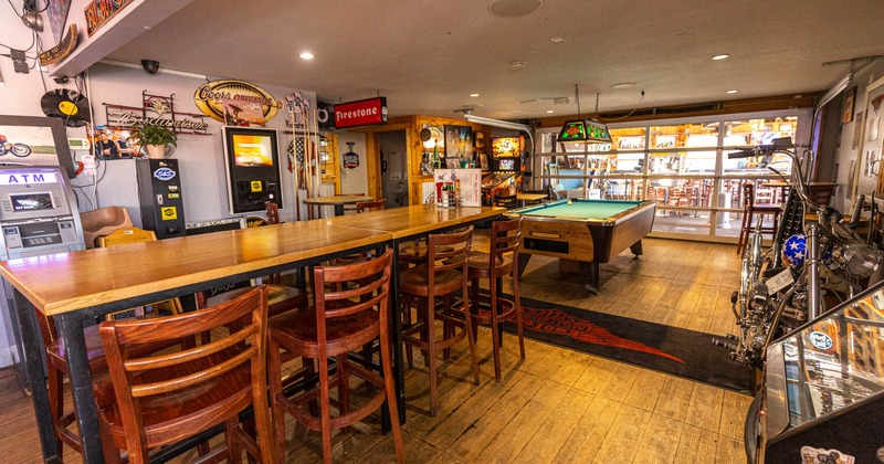 Interior, game room with a billiard table, tall tables and chairs