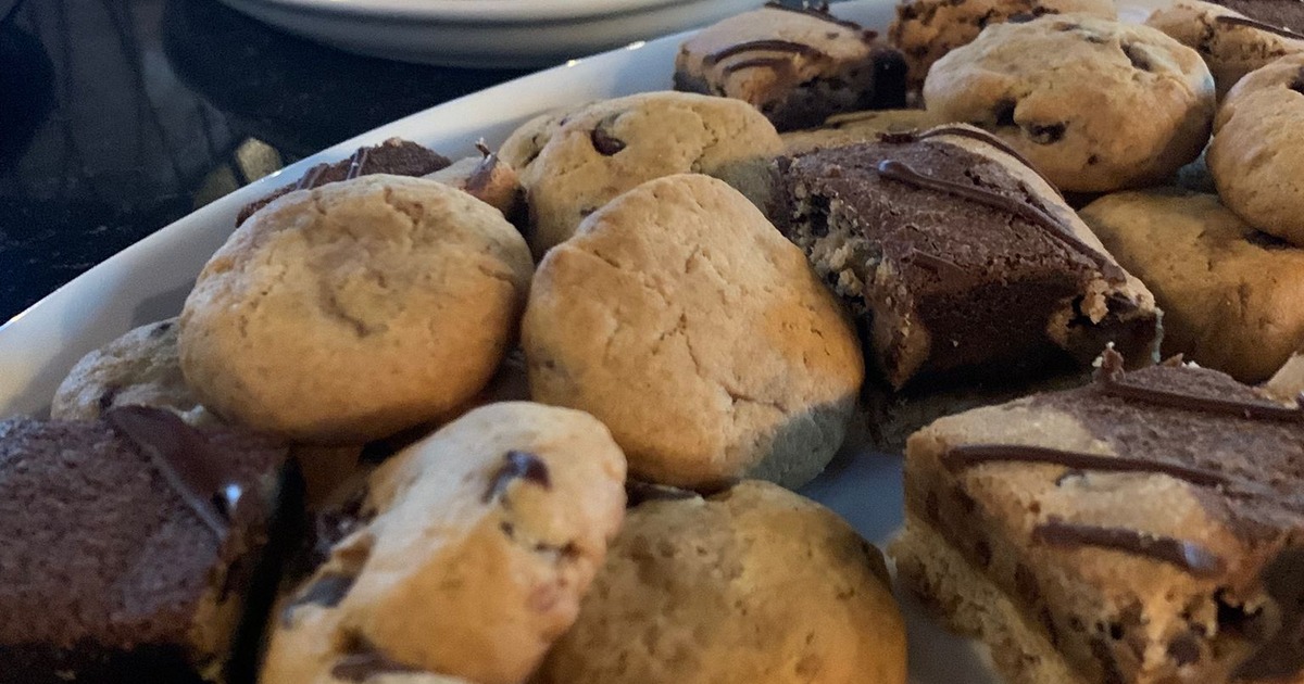 A close-up of a plate filled with an assortment of cookies and brownies