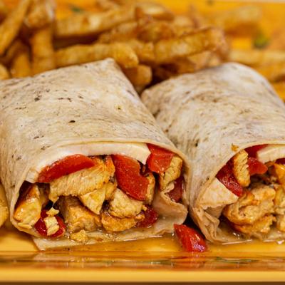 Chicken wrap served with fries.