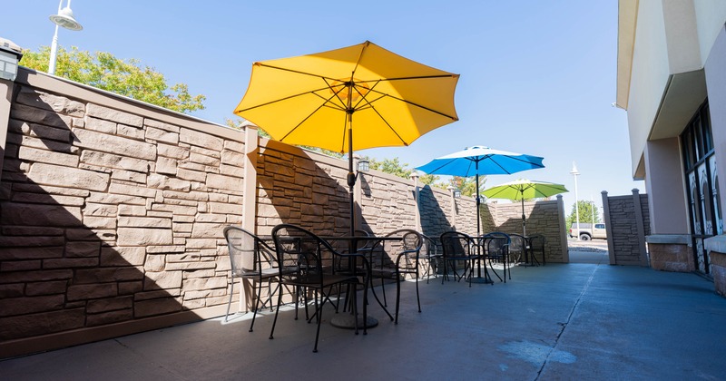 Outdoor patio with metal tables and colorful umbrellas