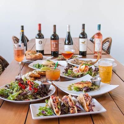 Assortment of dishes and drinks arranged on a wooden table.