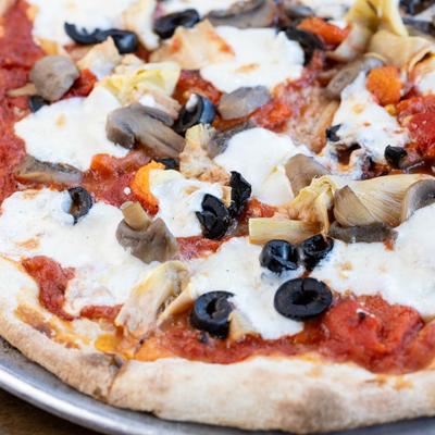 Pizza with tomato sauce, mozzarella, black olives, peppers, artichokes, and mushrooms.