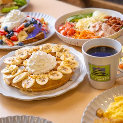 Various breakfast items served on the table with a cup of coffee.