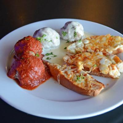 Garlic bread served with meatballs.