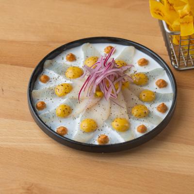 A dish of white fish citrus infused in sauces, served with crispy plantains.