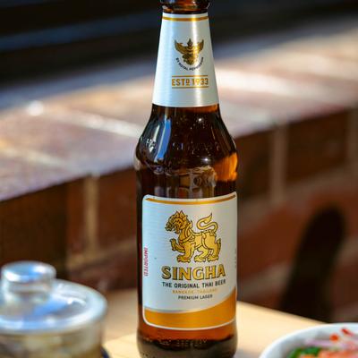 A bottle of Thai lager on a table.
