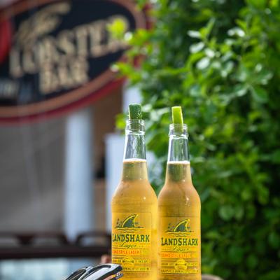 Two bottles of beer garnished with lime slices.