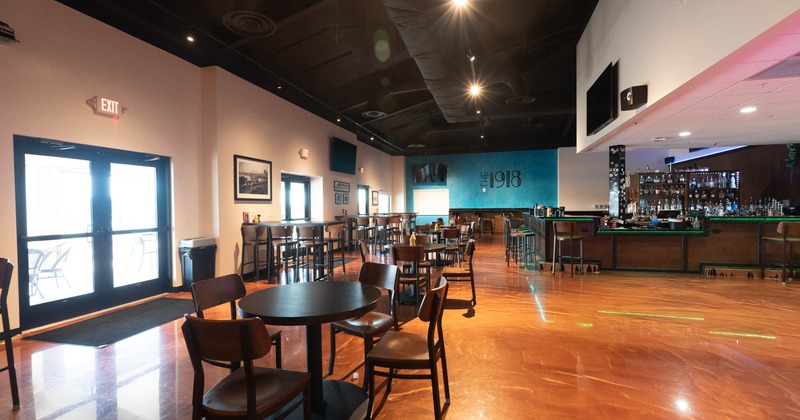 Interior, large open space seating area, restaurant entrance, bar on the right