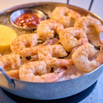 Shrimp on ice with cocktail sauce.