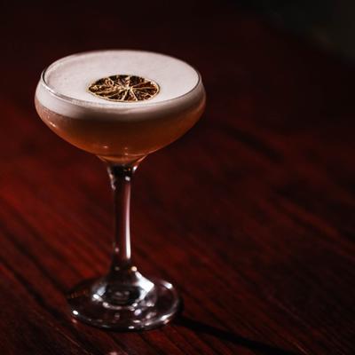 Blackberry Martini cocktail gernished with dried lime wheel.