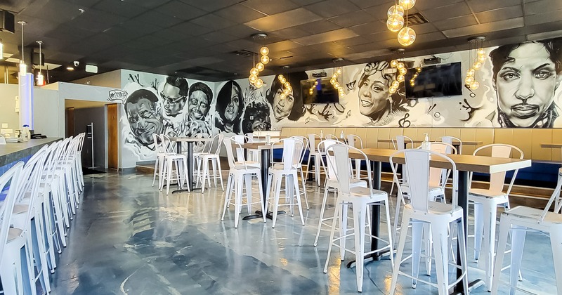 Interior, tables and seating waiting for guests, wall art