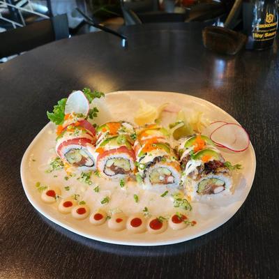 Plate of sushi rolls topped with various ingredients.