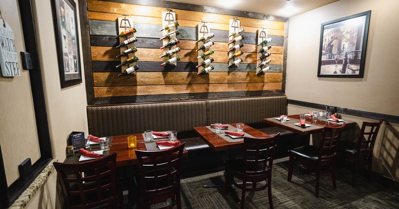 Interior, diner room, tables and chairs, assorted wine in wall rack above
