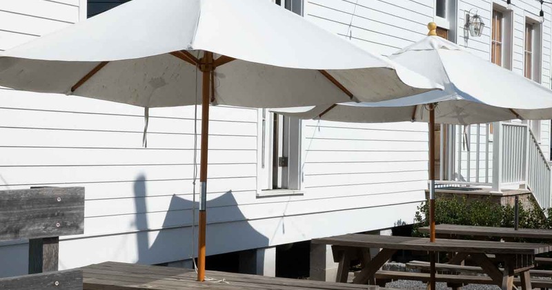 Exterior, seating place in front a restaurant in the shade of the parasol
