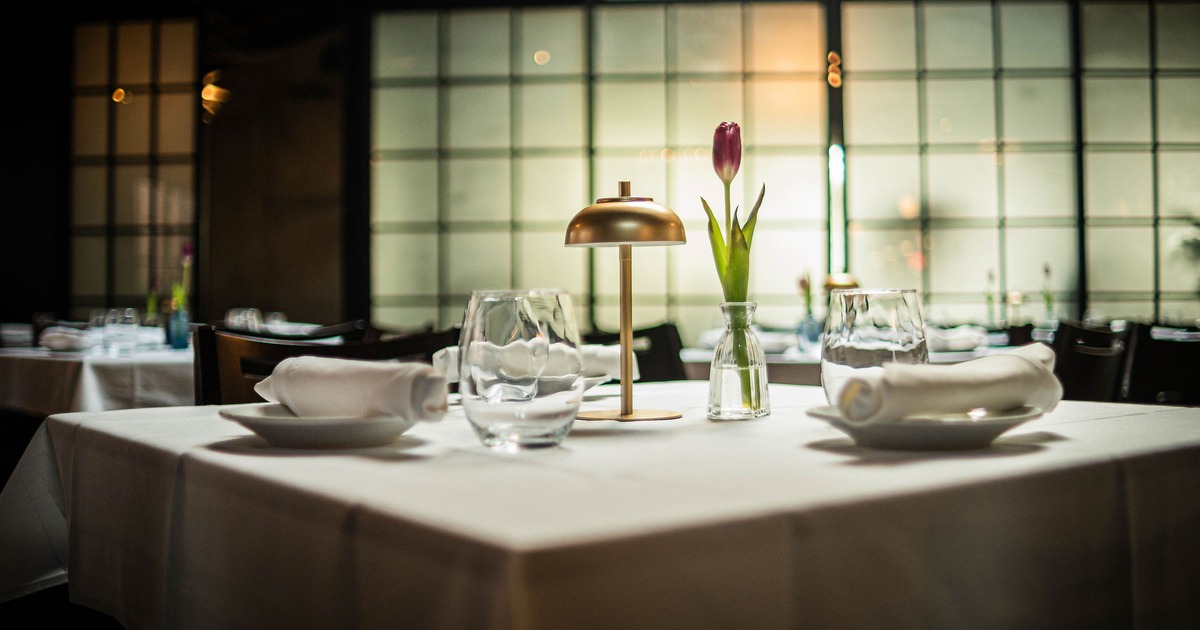 An elegant dining setup with a table for four guests, close up