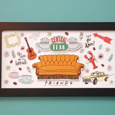 A framed Friends poster on a wall.
