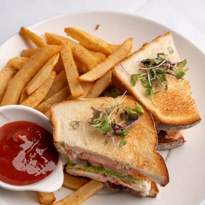 Lobster BLT sandwich served with fries and dipping sauce.