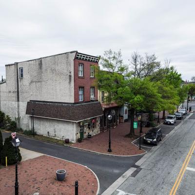 Exterior, trees, parked cars, road, sidewalk.